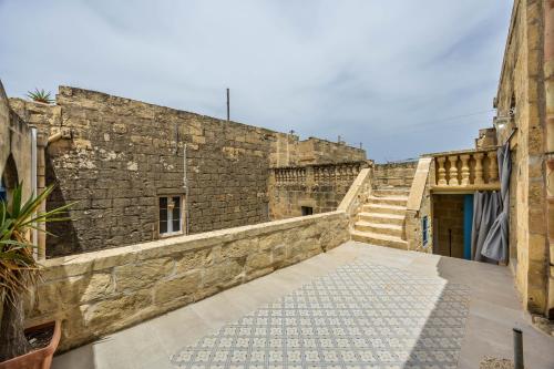 an alley in an old stone building with stairs at Room 5 - Twin Room x 2 by Solea in Għarb