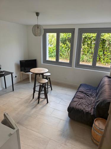 un salon avec un lit et une table dans l'établissement Studio équipé - Parking, à Saint-Gaudens