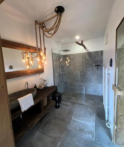 a bathroom with a sink and a shower at Sonnberg Chalet - Entspannung pur im Luxus Chalet mit Whirlpool-Sauna in Lachtal
