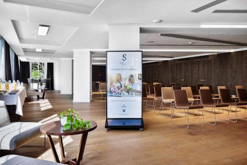 a large sign in the middle of a room with chairs at Pure Salt Garonda - Adults Only in Playa de Palma