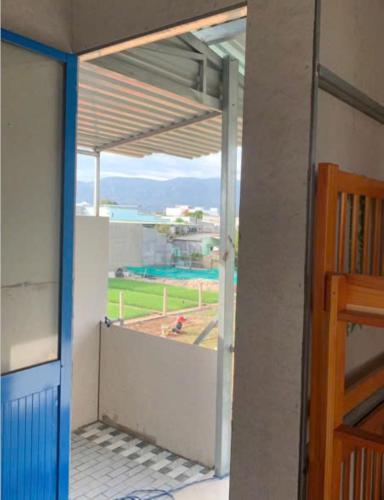 an open door to a balcony with a view at Nomad Stay in Phan Rang