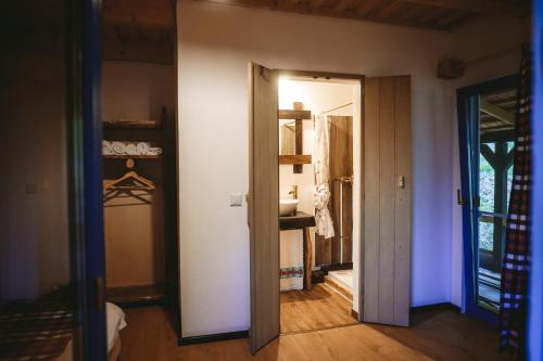 an open door in a room with a bathroom at Casa Mariș in Vadu Izei