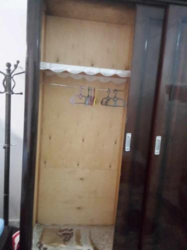 a closet with two pairs of glasses on a shelf at Nubian Life Nile View in Aswan
