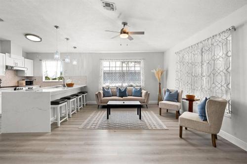 a kitchen and living room with a couch and a table at Isla Living, 3 Bed, Canal, Pool in Anna Maria