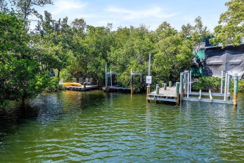 a body of water with trees and a dock at Isla Living, 3 Bed, Canal, Pool in Anna Maria