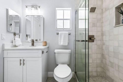 a bathroom with a toilet and a glass shower at Isla Living, 3 Bed, Canal, Pool in Anna Maria
