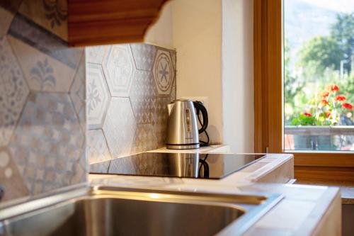 a coffee pot sitting on top of a stove in a kitchen at Maison Marcel Sarre in Aosta