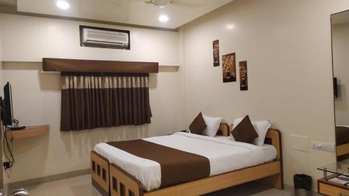 a bedroom with a bed in a room at Aquarius Resort in Pune