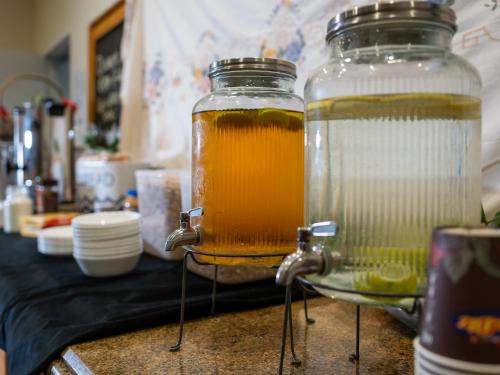 two glass jars filled with liquid on a counter at Azzurro Boutique Hotel - Surry Hills in Sydney