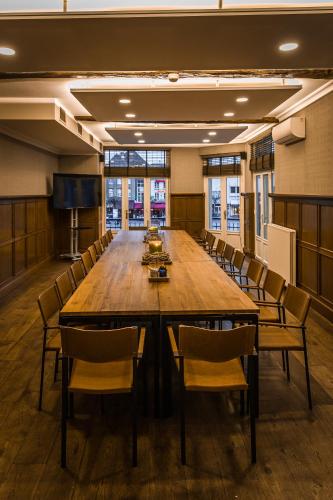 a large conference room with a large wooden table and chairs at Hotel De Limbourg in Sittard
