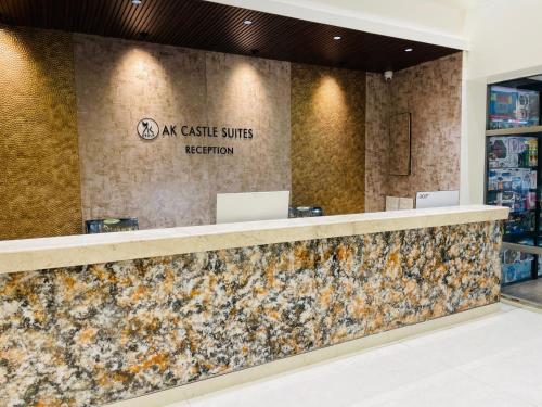 a stone counter in a store with a sign on the wall at AK Castle Suites in Bengaluru
