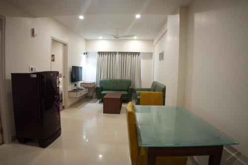 a living room with a couch and a table in a room at AK Castle Suites in Bengaluru