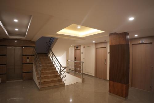 a hallway with a staircase in a building at AK Castle Suites in Bengaluru