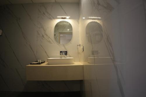 a bathroom with a sink and a mirror at AK Castle Suites in Bengaluru