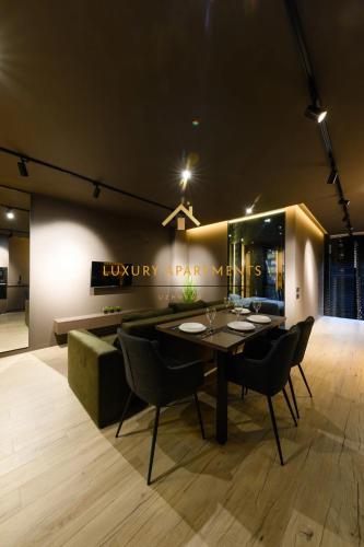 a dining room with a table and chairs at Luxury Apartments-Belochka in Uzhhorod
