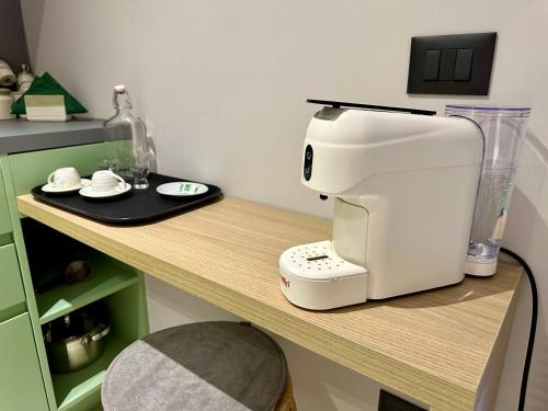 a white coffee maker sitting on a table at Lili's Tirana Center Apartments in Tirana