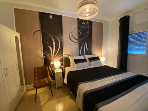 a bedroom with a large bed and a chair at Cortijo Los Corazones in Cantoria