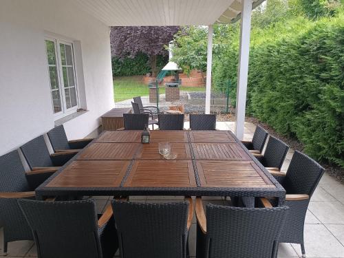a wooden table and chairs on a patio at Ferienhaus Urlaubstraum in Ueckermünde