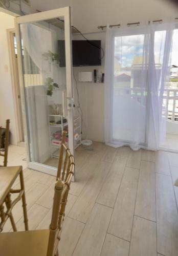 a living room with a table and a sliding glass door at Rominaluxe Property Rentals in Solano