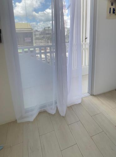 a room with a window with white curtains at Rominaluxe Property Rentals in Solano