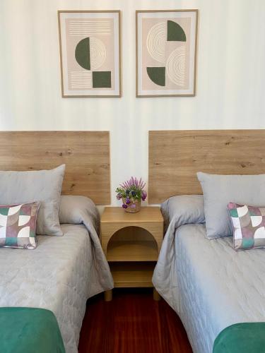 two beds sitting next to each other in a room at Aloha T in Porriño