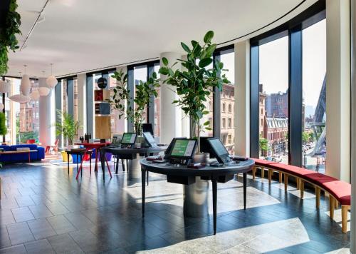 a lobby with two tables with laptops on them at citizenM Boston Back Bay in Boston