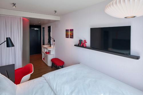 a bedroom with a bed and a flat screen tv on the wall at citizenM Boston Back Bay in Boston