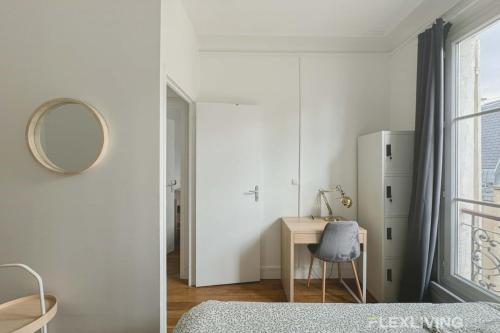 a white bedroom with a desk and a refrigerator at Flexliving - room - Lemoine in Paris