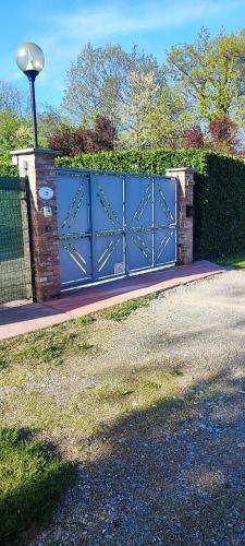 a blue gate in front of a house at casa margherita in Borgo San Dalmazzo