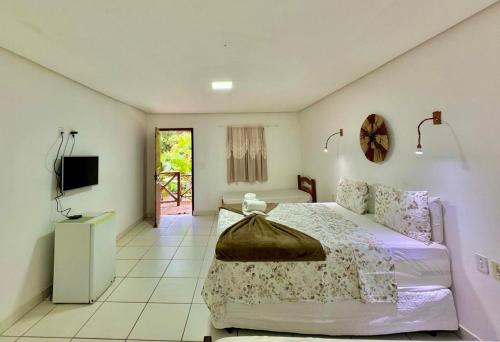 a bedroom with a bed and a television in it at Bosque do Lapão in Lençóis