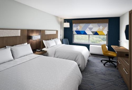 a hotel room with two beds and a desk and a window at Holiday Inn Express & Suites Tumwater - Olympia by IHG in Tumwater