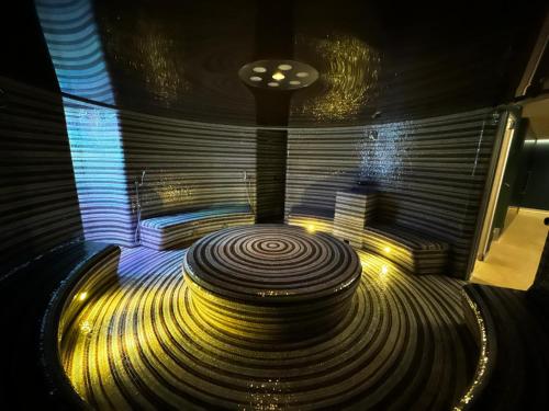 a dark room with a spiral staircase with lights at Mountain Apartment Resident - relax s wellness, terasou a soukromou garáží in Harrachov