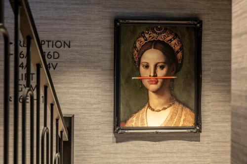 a painting of a woman with a stick in her mouth at BizStay Delft in Delft