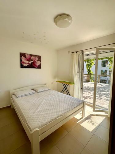 a bedroom with a bed and a sliding glass door at Anubis in Budva