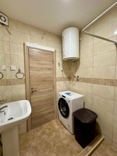 a bathroom with a washing machine and a sink at Anubis in Budva