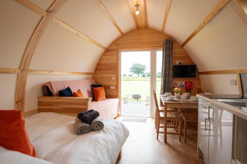 a room with a bed and a kitchen in a house at Eden Valley by Wigwam Holidays in Cumwhinton