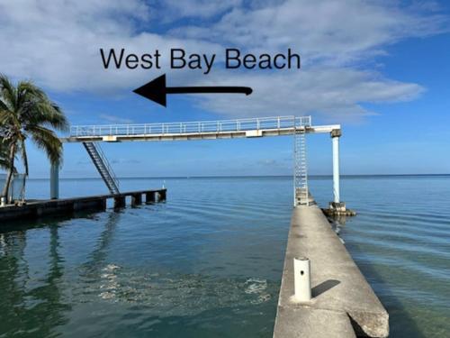 a dock in the water with a west bay beach at Palm Luxury King Suite, Pool, ocean views, beach short walk West Bay West End in West Bay