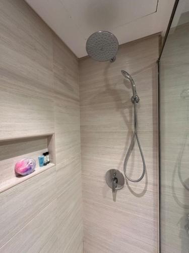 a shower with a shower head in a bathroom at VIP Luxury Premium Apartment in Manama