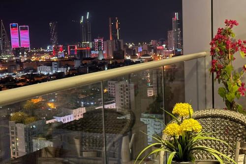 a balcony with a view of a city at night at VIP Luxury Premium Apartment in Manama