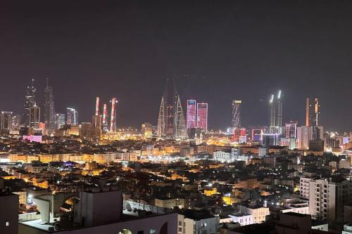 a city skyline at night with lit up buildings at VIP Luxury Premium Apartment in Manama
