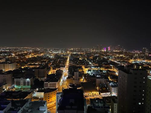 a view of a city at night with lights at VIP Luxury Premium Apartment in Manama