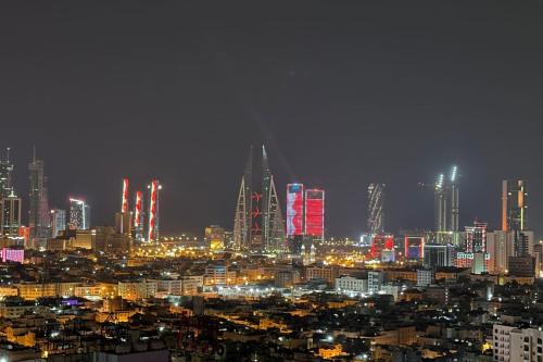 a city skyline at night with lit up buildings at VIP Luxury Premium Apartment in Manama