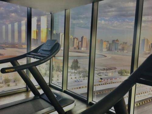 a gym in a building with a view of a city at High Floor Era View Tower City View in Manama