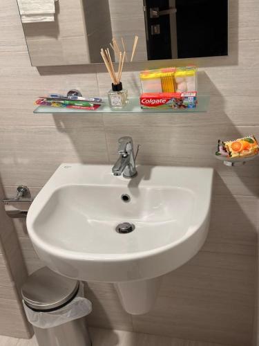 a white sink in a bathroom with a mirror at VIP Luxury Premium Apartment in Manama