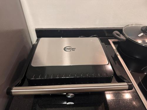 a laptop computer sitting on top of an oven at VIP Luxury Premium Apartment in Manama