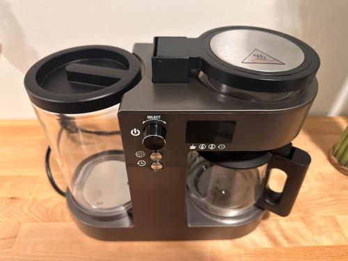 a coffee maker sitting on top of a table at VIP Luxury Premium Apartment in Manama