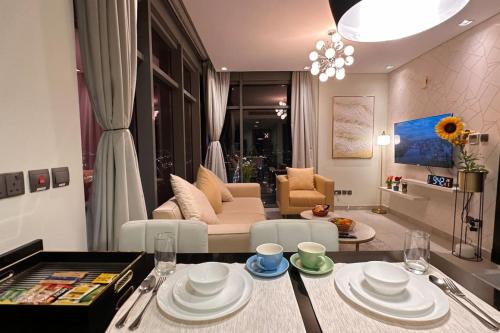 a living room with a table and a couch at VIP Luxury Premium Apartment in Manama
