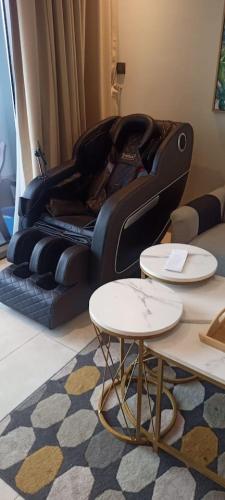 a black couch in a living room with two tables at High Floor Era View Tower City View in Manama