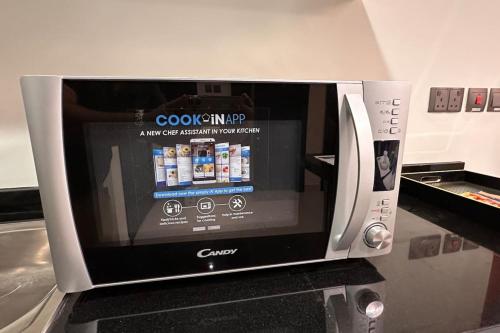 a microwave oven sitting on top of a counter at VIP Luxury Premium Apartment in Manama