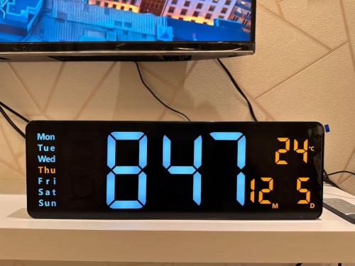 an alarm clock sitting on top of a table at VIP Luxury Premium Apartment in Manama